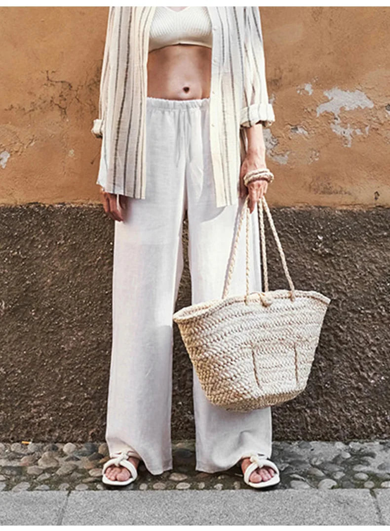 FJØRNA women's knit wide-leg trousers with drawstring waist, shown in a relaxed fit, soft fabric, and stylish design.
