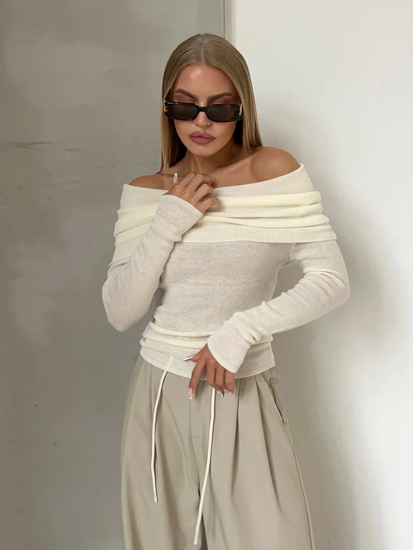 FJØRNA ribbed knit off-shoulder women's top with mock neck, showcasing a fitted, stylish design in a neutral color.
