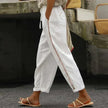 FJØRNA linen summer trousers for women, high waist, tapered fit, light and breathable fabric ideal for warm weather.
