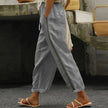 FJØRNA women's linen summer trousers, tapered high waist, light and breathable fabric, shown in a natural relaxed fit style