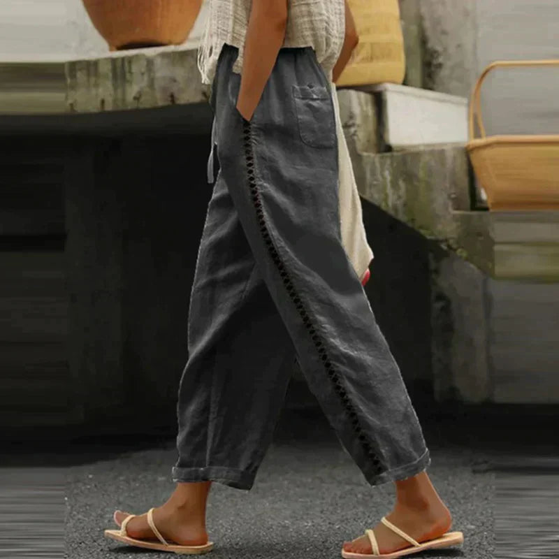 FJØRNA women's linen summer trousers with tapered fit and high waist, beige color, casual stylish women’s clothing.