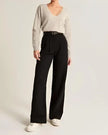 White wide-leg high-waist trousers for women by FJØRNA, featuring a relaxed fit and elegant high-waist design.