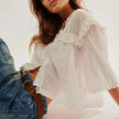 FJØRNA white cropped cotton blouse for women with lace trim, stylish top featuring a feminine design and lightweight fabric.