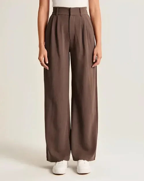 White wide-leg high-waist trousers for women by FJØRNA, featuring a relaxed fit and tailored high-rise design.