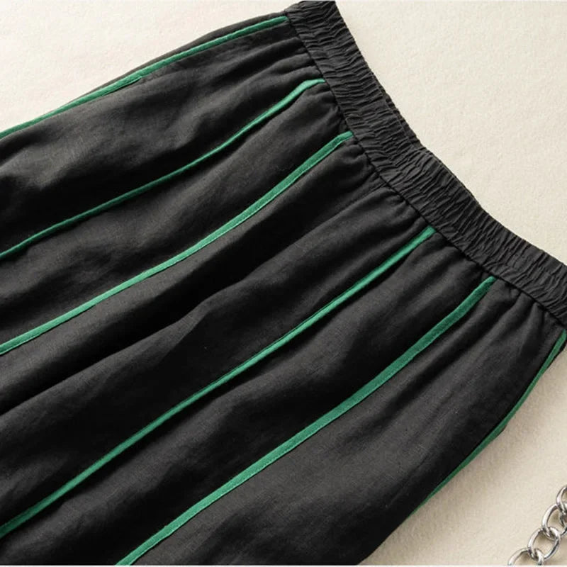 FJØRNA linen wide leg women's trousers with elastic waist, relaxed fit, and flowing fabric, perfect for casual or summer wear.