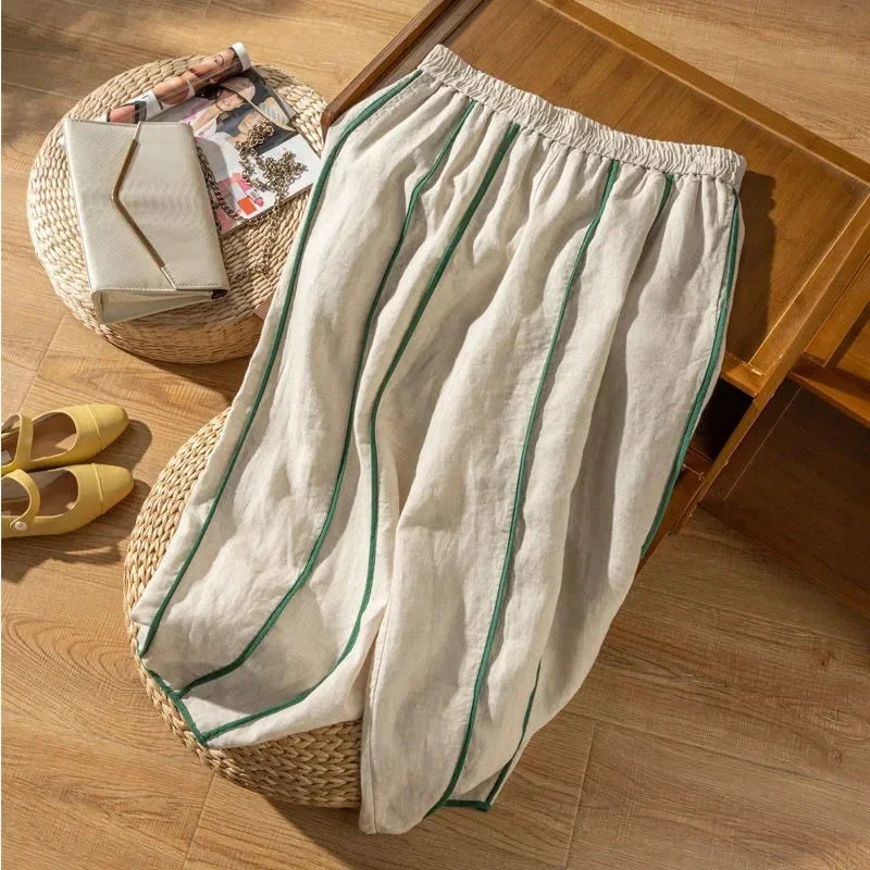 FJØRNA women's linen wide-leg trousers with elastic waist, light and breathable fabric, shown on a person standing.