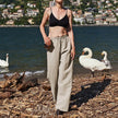 FJØRNA women's knit wide-leg trousers with drawstring waist, soft fabric, and relaxed fit, shown on a model.