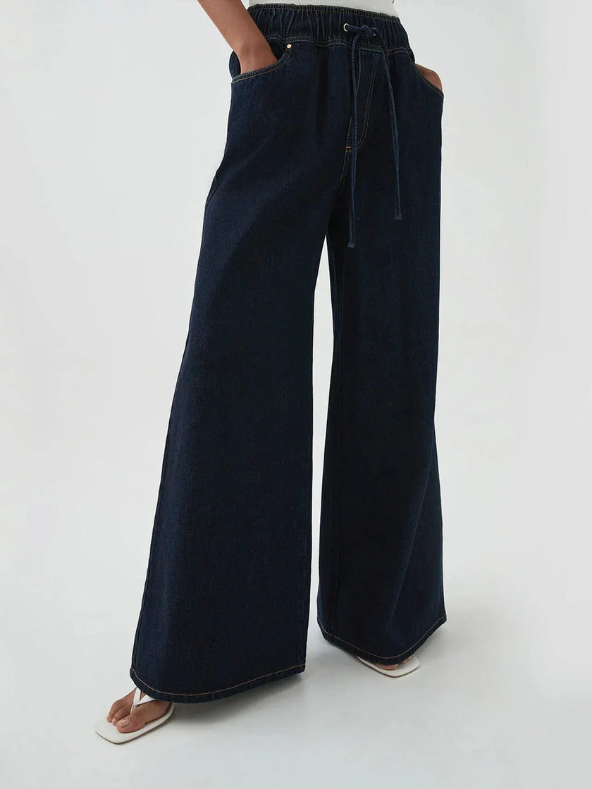 Blue denim wide-leg drawstring pants for women by FJØRNA, relaxed fit jeans with a comfortable waist and casual style.