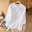 FJØRNA women's floral summer blouse with V-neck and ruffle accents, made of lightweight linen fabric, perfect for warm weather.