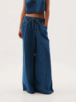Blue denim wide-leg drawstring women's jeans by FJØRNA, relaxed fit pants with a casual, stylish design.