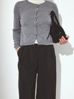 Longline women's button-front knit cardigan by FJØRNA, showcasing a cozy, stylish knit top with a relaxed fit and button details.