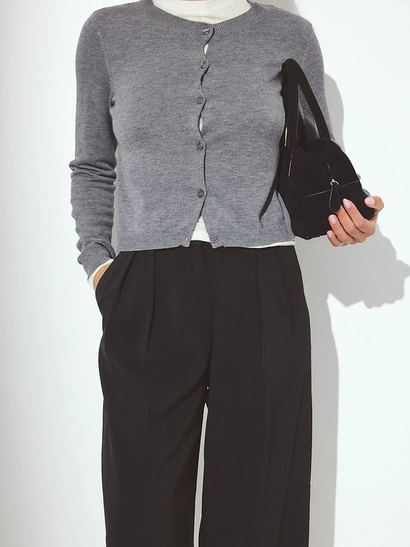 Longline women's button-front knit cardigan by FJØRNA, showcasing a cozy, stylish knit top with a relaxed fit and button details.