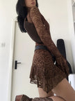 FJØRNA sheer lace mini dress for women, perfect for party and day wear, featuring delicate lace details and a fitted silhouette.