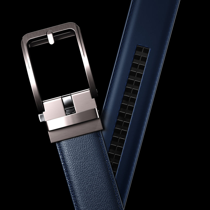 Blue vegan leather ratchet belt by FJØRNA, adjustable unisex belt with sleek design, shown in a close-up shot.