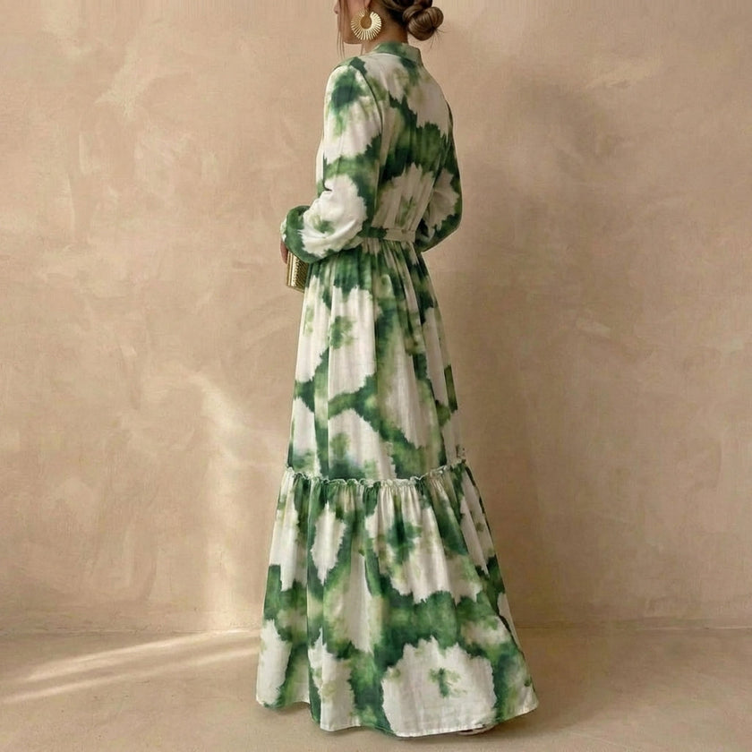 Side view of a women's elegant maxi dress by FJØRNA, featuring a V-neck and long sleeves in flowing fabric.