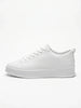 FJØRNA white men's slip-on trainers with a clean, minimalist design shown from the side profile. Casual shoe for everyday wear.