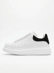 FJØRNA men's white lace-up trainers with minimalist design, side profile view showcasing casual and versatile everyday shoes.