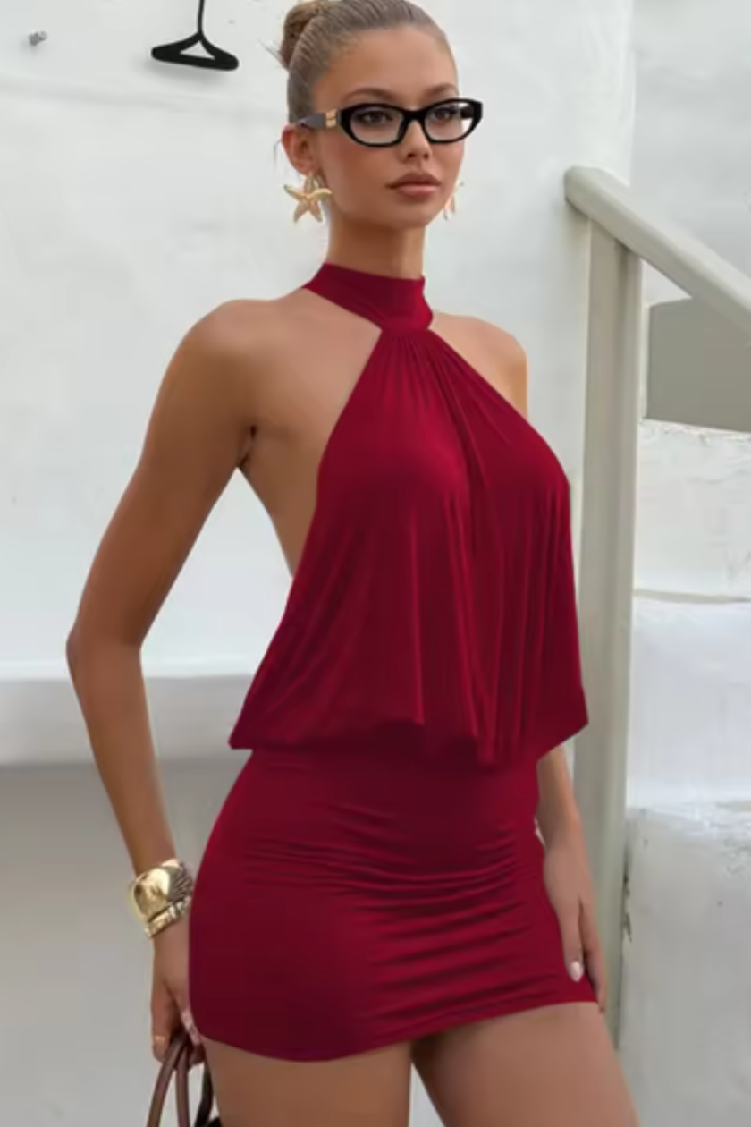 FJØRNA women's halter neck mini dress with draped top, backless design, and fitted bodycon style for party wear.