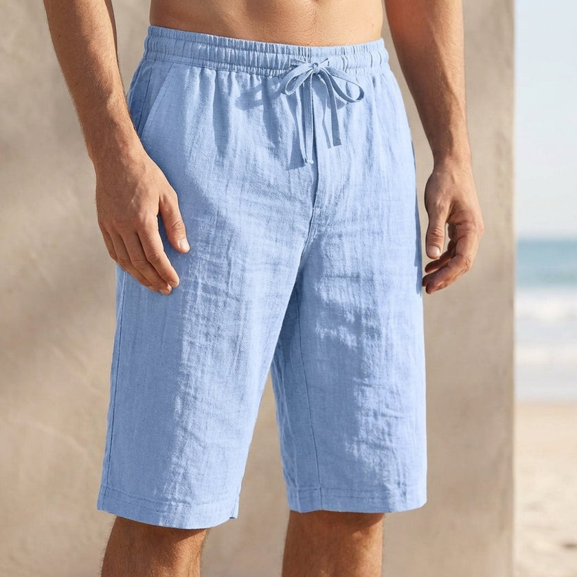 Sky blue men's FJØRNA linen drawstring chino shorts with a tailored fit and relaxed waistband, suitable for casual summer wear.