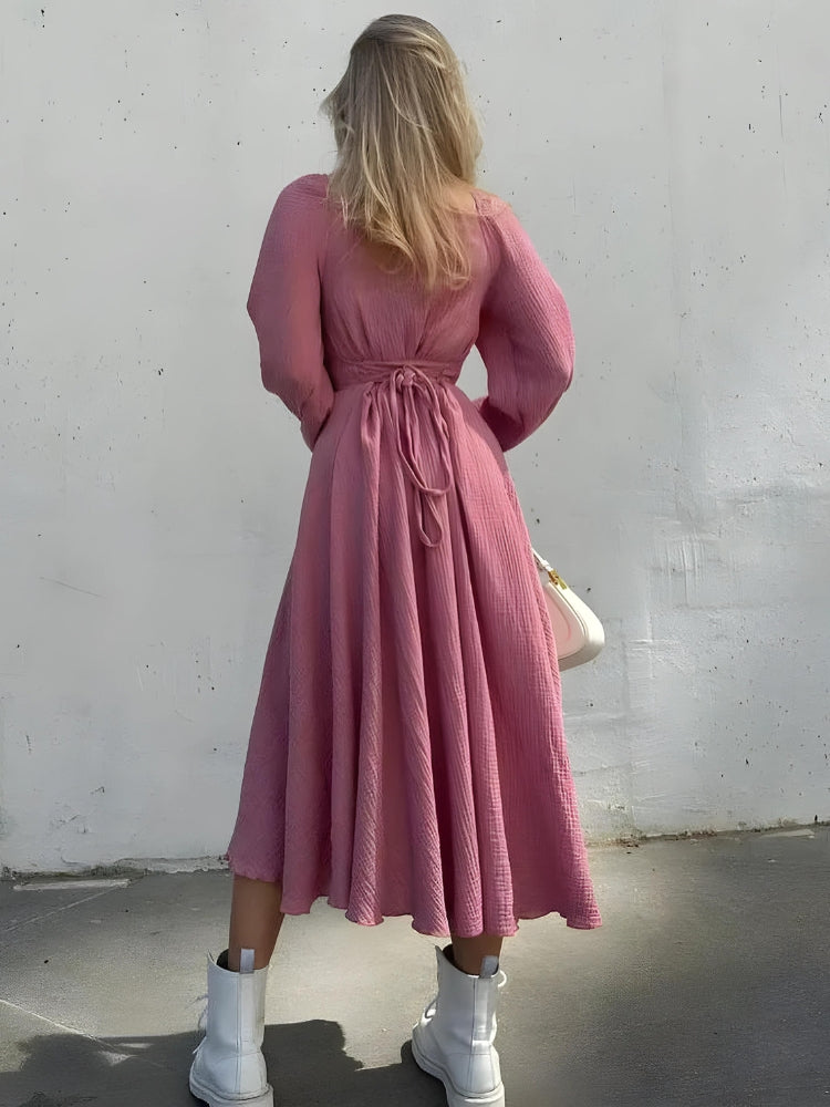 FJØRNA slit women's midi dress featuring a stylish side slit, perfect for day-to-night wear, shown in a sleek fabric.
