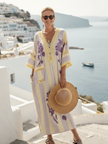 FJØRNA women's summer maxi dress with floral pattern and pockets, flowing fabric, and sleeveless design.