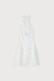White polka dot mini dress by FJØRNA featuring a voluminous skirt, perfect for party and daytime wear.