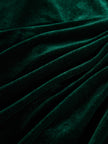 FJØRNA velvet midi evening dress with elegant drape and long sleeves, displayed on a mannequin.