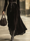 FJØRNA velvet v-neck maxi dress for evening wear, featuring a flowing silhouette and elegant V-neck design.