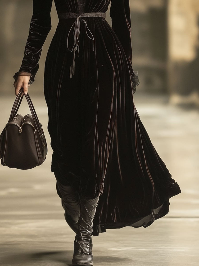 FJØRNA velvet v-neck maxi dress for evening wear, featuring a flowing silhouette and elegant V-neck design.