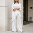 White summer two-piece women's co-ord set by FJØRNA featuring an asymmetric top and matching shorts.