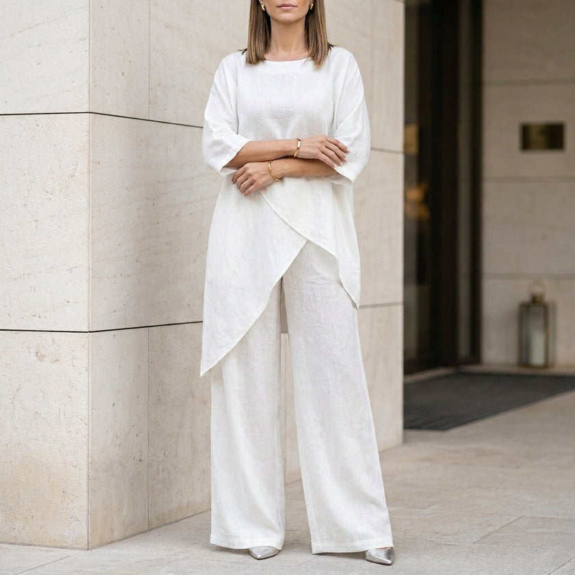 White summer two-piece women's co-ord set by FJØRNA featuring an asymmetric top and matching shorts.