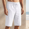FJØRNA beige linen drawstring chino shorts for men, tailored linen pants with side pockets and relaxed fit.