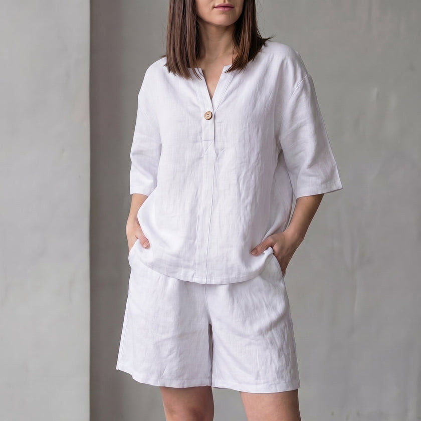 White FJØRNA women's two-piece co-ord set with V-neck top, lightweight fabric, and pockets, perfect for casual wear.