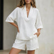 White FJØRNA summer two-piece women's co-ord set with flowy fabric and V-neck design, shown on a model.