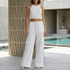 White women's summer two-piece co-ord set with pockets and halter neck by FJØRNA, perfect for warm-weather casual wear.