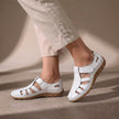 White FJØRNA orthopedic closed-toe sandals with cutout details and a comfortable fit, showcasing the stylish design.