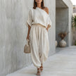 White FJØRNA women's two-piece co-ord set with one-shoulder design and pockets, stylish and elegant for casual or dressy wear.