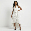 White FJØRNA elegant maxi dress for women featuring halter neck and ruffle satin details, perfect for formal occasions.
