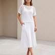 White FJØRNA women's two-piece knit cropped co-ord set with a fitted top and matching high-waisted pants.