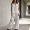 FJØRNA women's two-piece striped wide-leg set featuring a white top and matching pants for a stylish, elegant look.