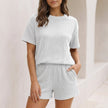 FJØRNA women's white two-piece knit co-ord set with pockets, featuring stylish, comfortable matching top and pants.
