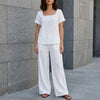 White summer two-piece women's co-ord set by FJØRNA featuring relaxed fit wide-leg pants and matching top.