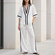 White FJØRNA women's two-piece co-ord set with wide-leg pants and V-neck top, perfect for stylish casual wear.