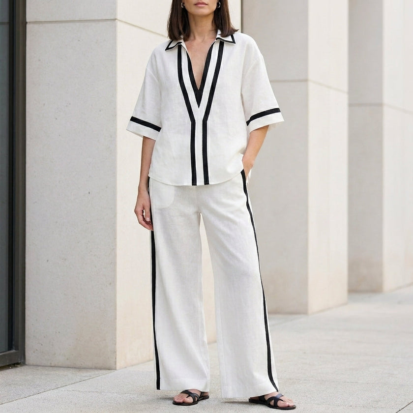 White FJØRNA women's two-piece co-ord set with wide-leg pants and V-neck top, perfect for stylish casual wear.