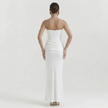 Back view of FJØRNA women's white strapless corset maxi dress with fitted bodice and flowing skirt.