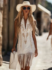 White denim tassel mini dress by FJØRNA, casual dress with fringe details, sleeveless design, and a relaxed fit.