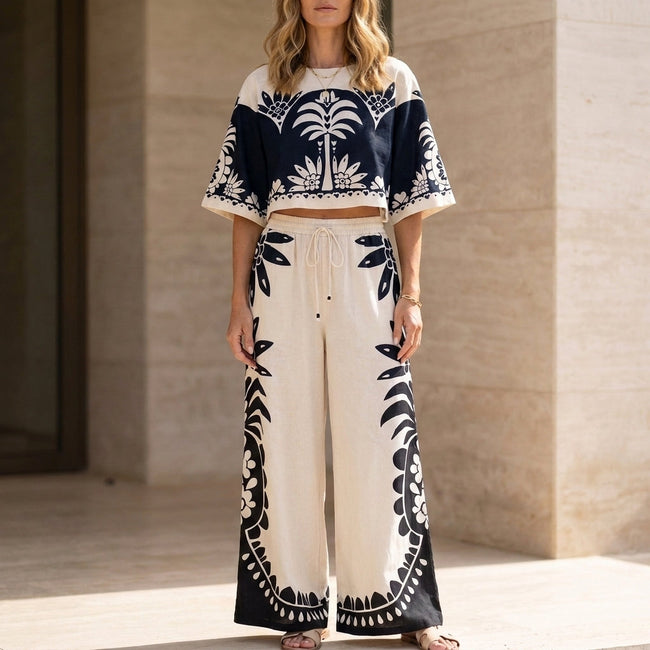 White FJØRNA women's two-piece co-ord set with print and drawstring, featuring a stylish and comfortable matching top and pants.