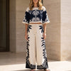 White FJØRNA women's two-piece co-ord set with print and drawstring, featuring a stylish and comfortable matching top and pants.