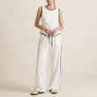 White women's summer two-piece set by FJØRNA featuring a button-front top and matching shorts, perfect for warm weather.