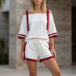White FJØRNA women's summer two-piece drawstring off-shoulder co-ord set with crop top and high-waisted shorts.
